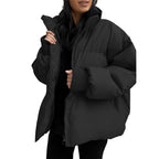 Person wearing a black puffer jacket against a white background