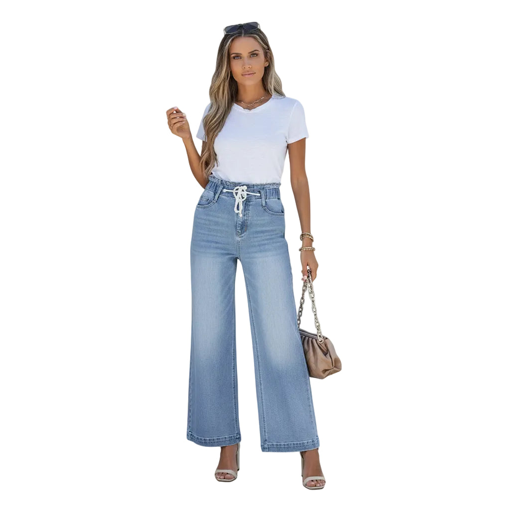 Woman wearing light blue jeans and a white top on a white background