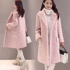 Woman wearing a pink coat with a gray background