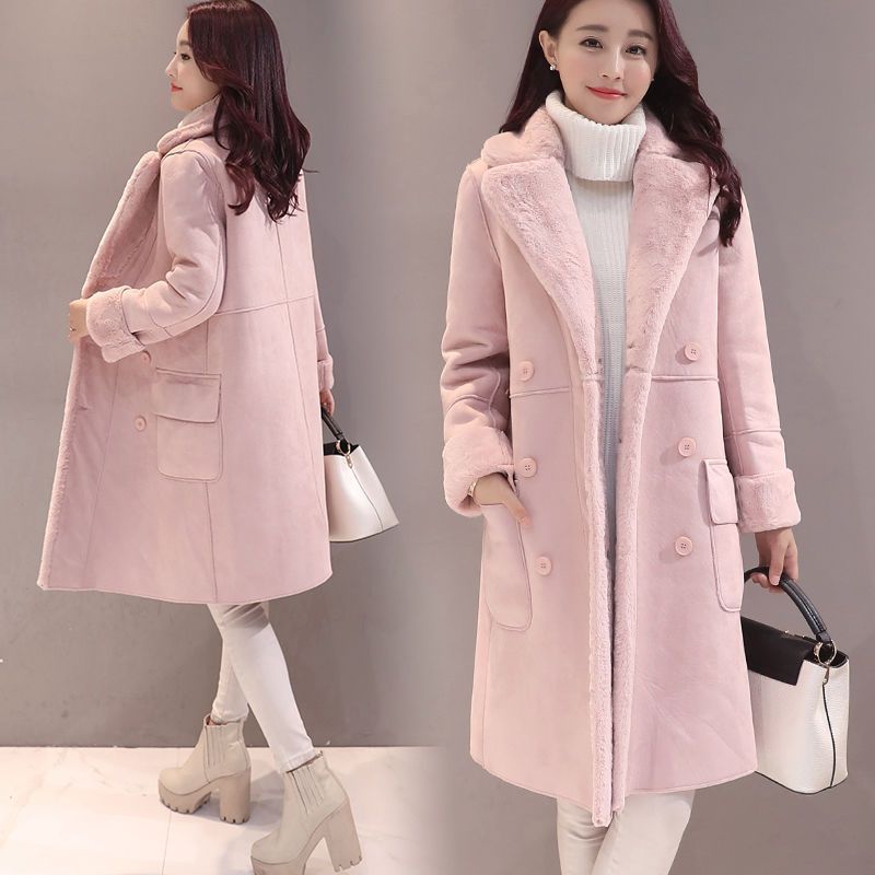 Woman wearing a pink coat with a gray background