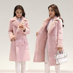 Two women wearing pink coats against a plain background