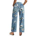 Floral embroidered jeans worn by a person on a street.