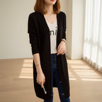 Black cardigan worn by a person with a blurred background