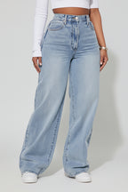 Light blue jeans worn by a person on a white background