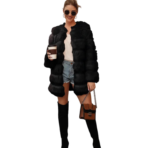 Woman wearing a black fur coat holding a coffee cup on a city street.