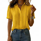 Person wearing a yellow shirt and blue jeans against a plain background