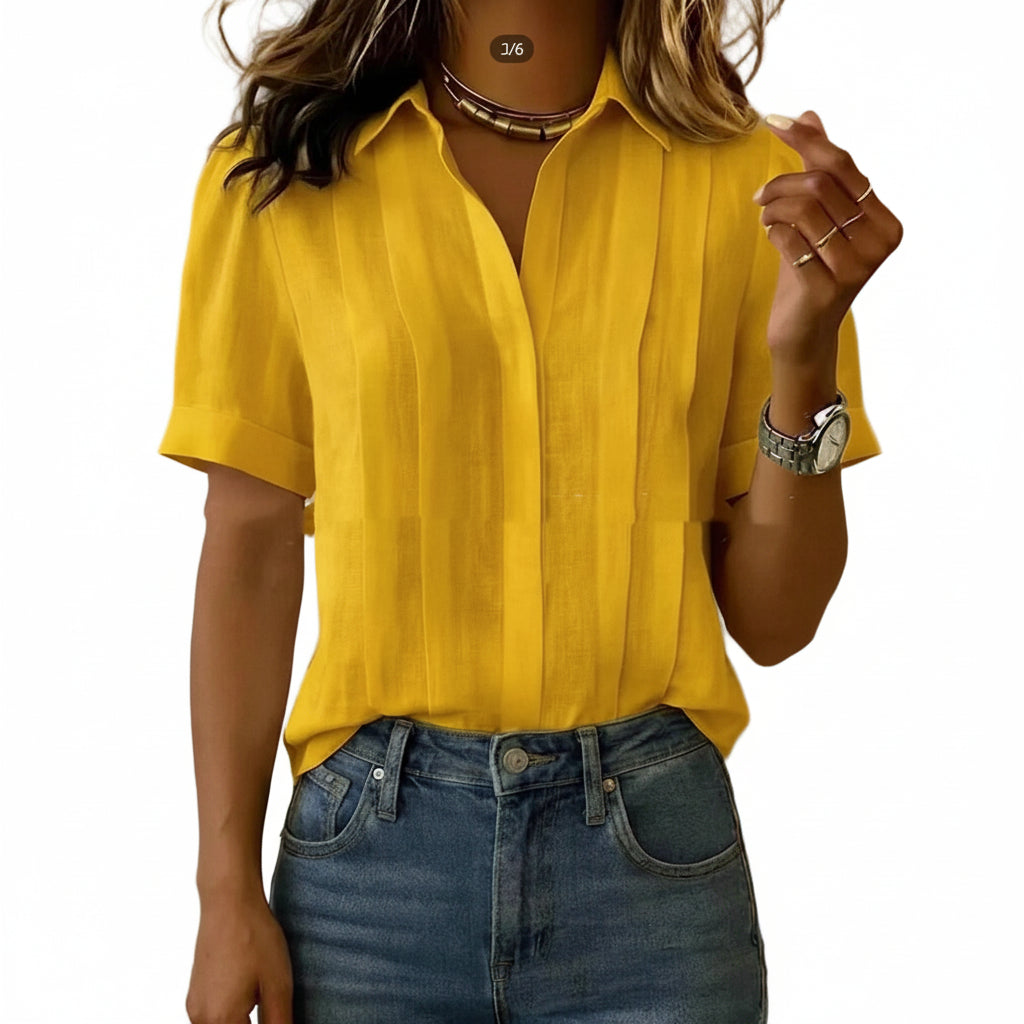 Person wearing a yellow shirt and blue jeans against a plain background