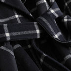 Close-up of a dark blue plaid fabric with white lines