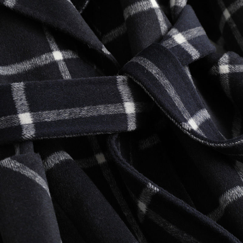 Close-up of a dark blue plaid fabric with white lines