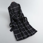 Black and white plaid coat on a gray background
