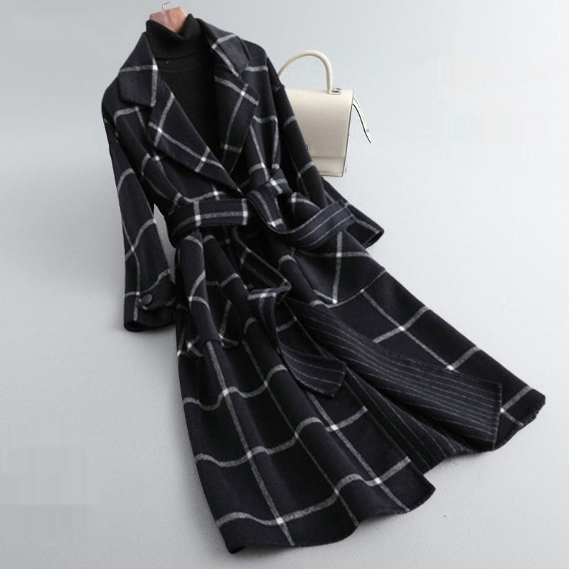 Black and white plaid coat on a light gray background