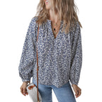Woman wearing a floral blouse and holding a handbag on a white background