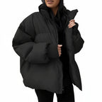 Person wearing a black puffer jacket against a white background
