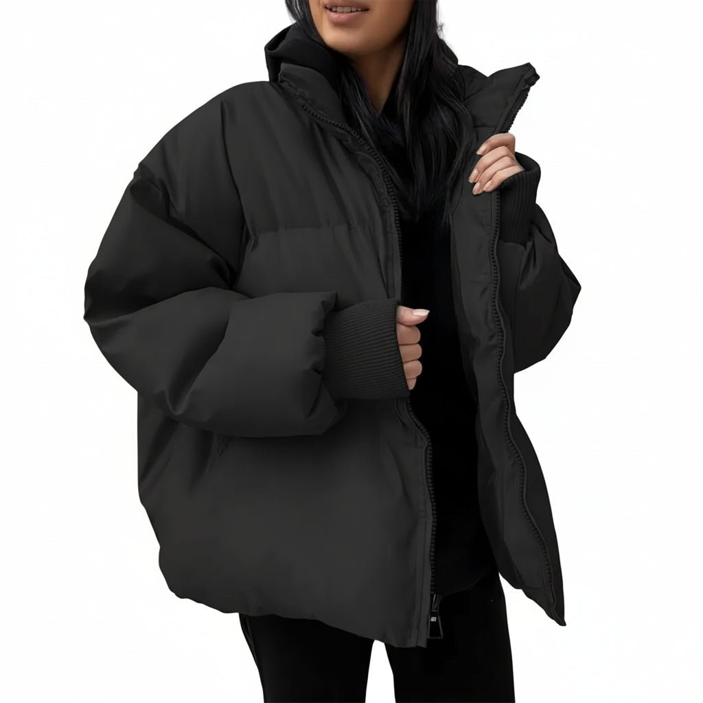 Person wearing a black puffer jacket against a white background