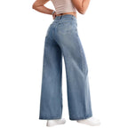 Person wearing light blue wide-leg jeans in a minimal indoor setting