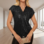 Black sequin top worn by a model on a white background