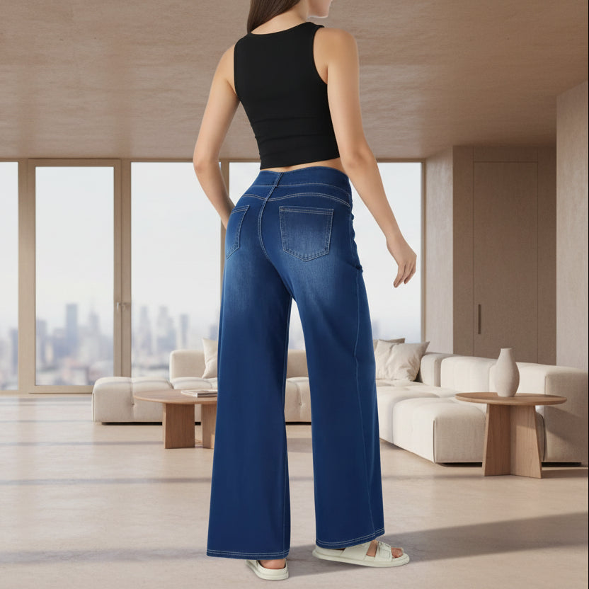 Person wearing blue wide-leg jeans on a plain background
