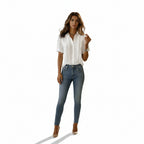 Person wearing a white button-up shirt and blue jeans against a plain background