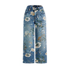 Floral-patterned jeans on a light gray background