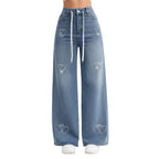Wide-leg jeans with heart designs on a white background