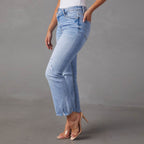 Light blue jeans worn by a person on a gray background