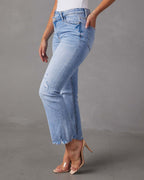 Light blue jeans worn by a person on a gray background