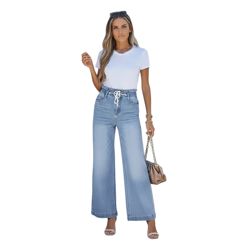 Woman wearing light blue jeans and a white top on a white background