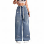 Wide-leg jeans with heart designs on a white background